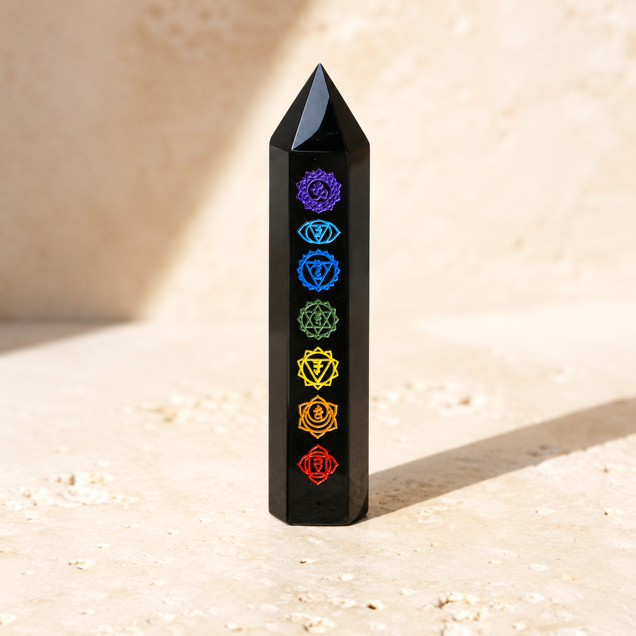 Black seven-emblem crystal tower on warm ivory limestone