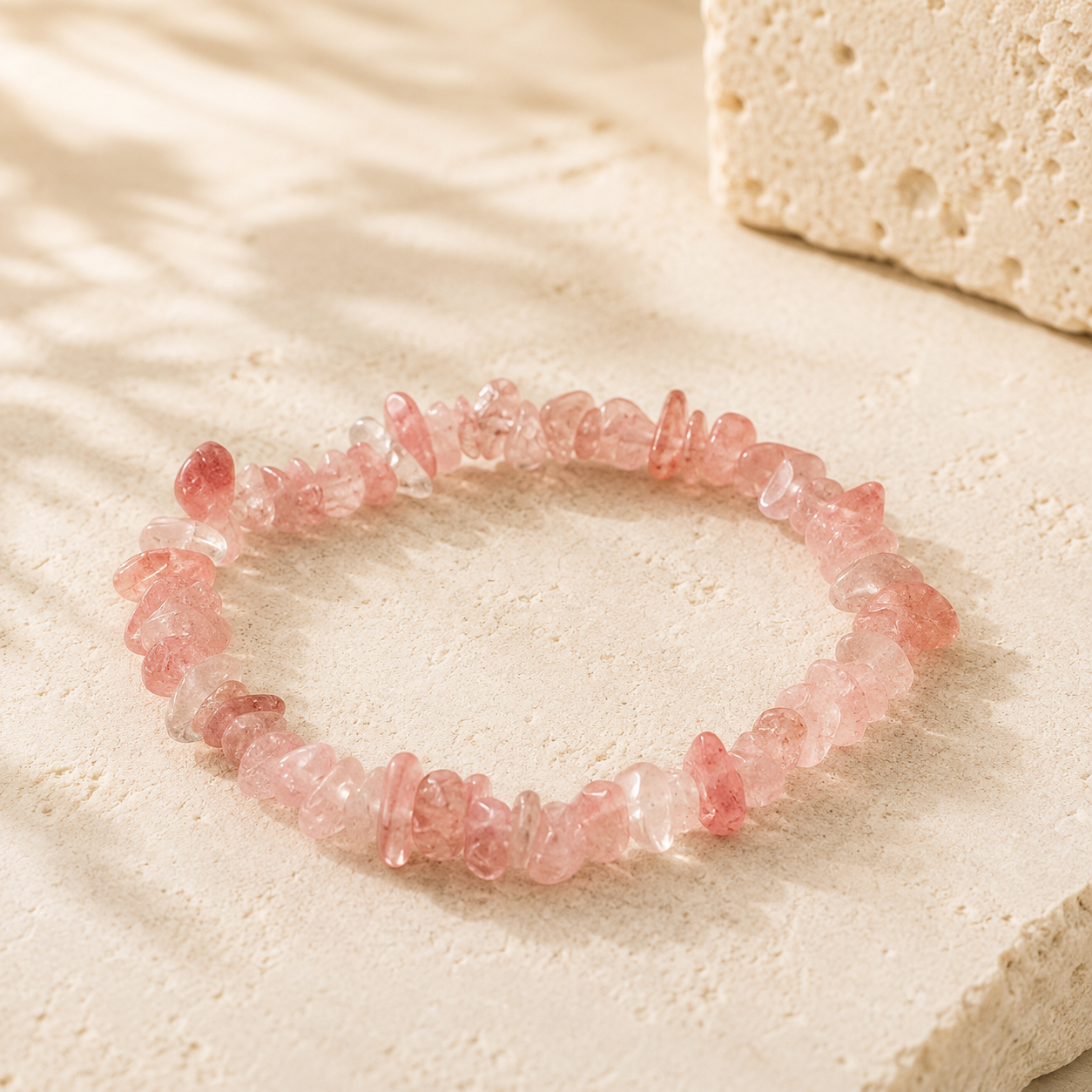 Blush pink natural crystal chip bracelet on warm ivory limestone
